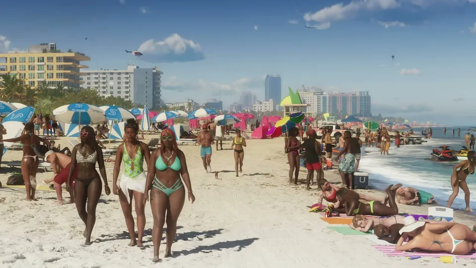 A crowded urban beach scene shows numerous people in swimwear, colorful umbrellas, buildings in the background, and jet skis near the water's edge.