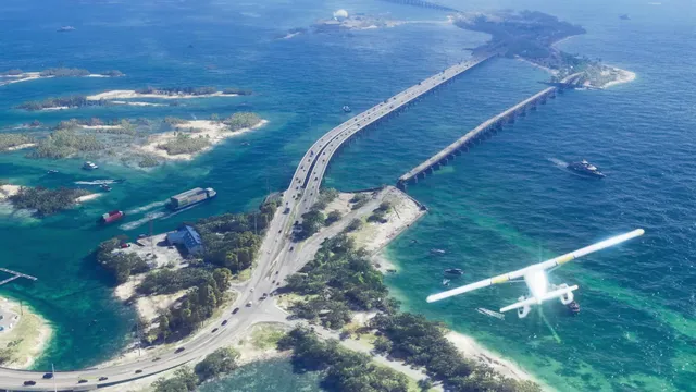 An aerial view shows a long highway bridge spanning across multiple small islands and turquoise waters, with…