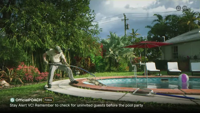 A man in a park ranger-like uniform uses a pole to remove an alligator from a residential swimming pool in a…