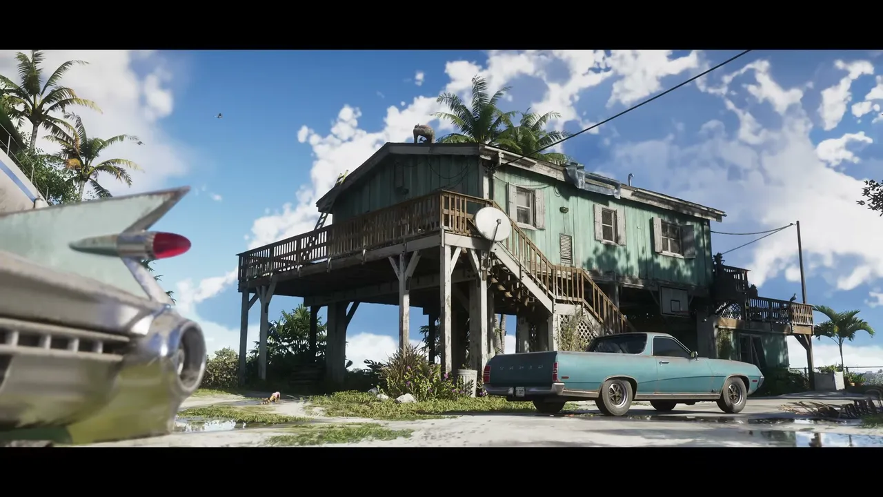 A weathered stilt house with a satellite dish and two classic cars parked outside under a blue sky…