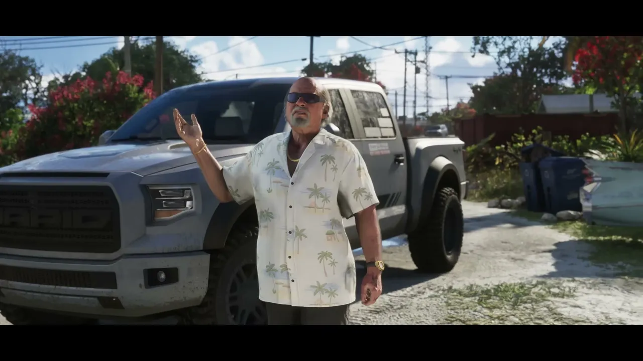 An older man wearing a tropical shirt and sunglasses stands next to a grey pickup truck, gesturing…