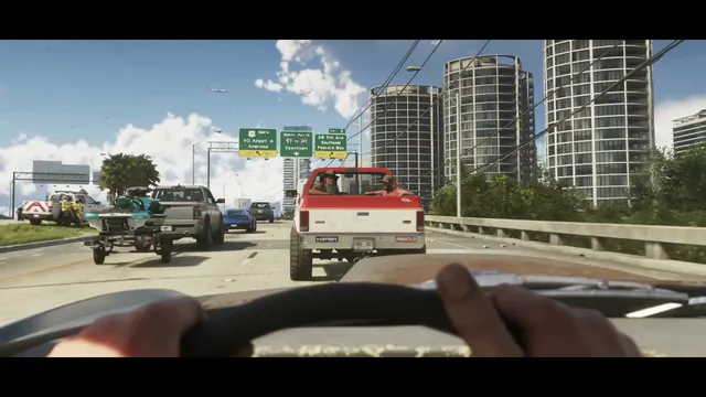 A first-person view from a car shows a multi-lane highway with traffic, including a red pickup truck with…