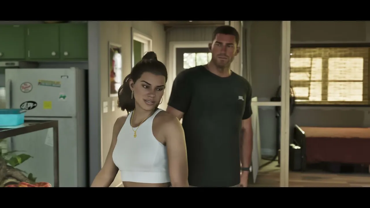 Lucia and Jason are standing inside a modest home, with a kitchen area visible to the left and a…
