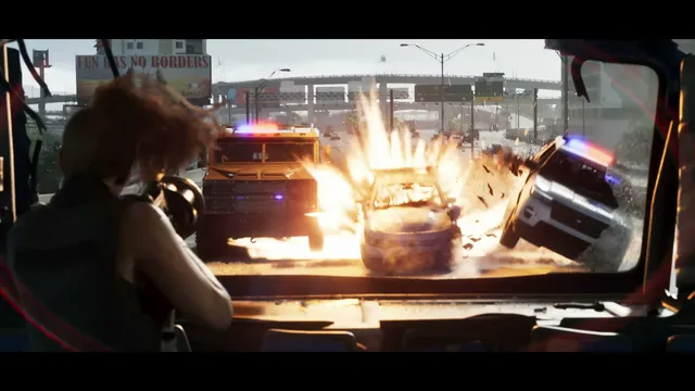 Lucia is seen from inside a vehicle, aiming a weapon towards a chaotic highway scene where a car explodes…