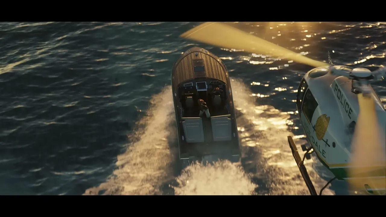 A police helicopter pursues a speedboat with two occupants over sun-dappled open water.